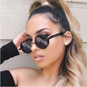 Retro punk style round sunglasses with black frames and dark lenses for men and women