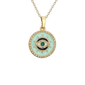 Golden necklace featuring a round evil eye pendant with green enamel and sparkling crystals