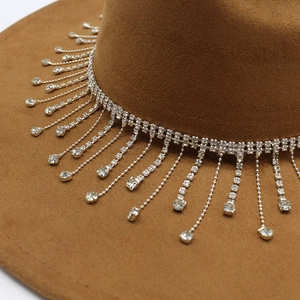 Detailed close-up of brown suede bridal hat featuring luxury sparkling diamond fringe