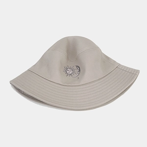 Close-up of artistic sun and moon embroidery on khaki cotton canvas bucket hat