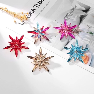Five elegant star-shaped crystal brooches in assorted colors with a vintage metal finish