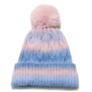 Tie-dye gradient knit beanie for women with a pink faux fur pompom and cable knit pattern