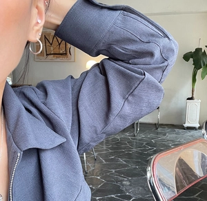 Close-up of textured long sleeve zipper top fabric and ribbed cuff details