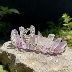 Detailed close-up of lavender crystal crown with silver moon and star on a mossy rock