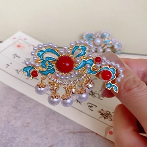 Detailed macro view of Chinese style hair clip with blue enamel and pearl tassels
