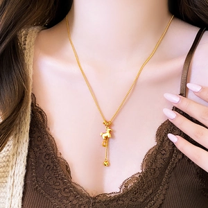 Golden Chinese zodiac horse pendant necklace with metal bead tassel on female model