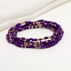Detail of double-layered purple and gold glass beads on a bikini waist chain