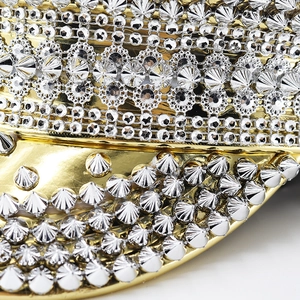 Macro detail of gold leather captain hat with silver rhinestones and metal rivets