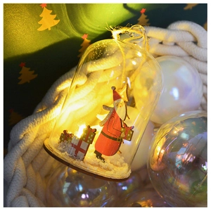 Detail of Christmas glass ornament with a wooden Santa Claus and warm LED light