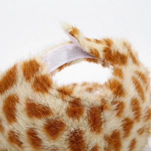 Macro detail of plush tiger print fabric with adjustable white hook and loop closure