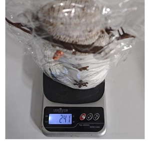 Detailed view of knitted Christmas snowman doll weighing 241g in transparent packaging