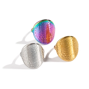 Textured stainless steel rings in rainbow, gold and silver finishes with grainy patterns