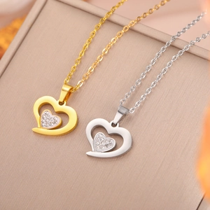 Detail of interlocking heart pendants with crystals in gold and silver finish