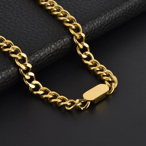 Polished gold rectangular pendant cuban link chain set on premium black leather background