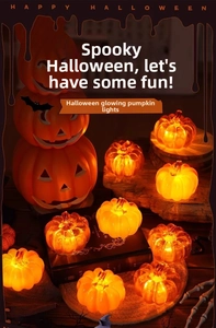 Close-up of LED Halloween pumpkin lantern set with warm light on decorative books