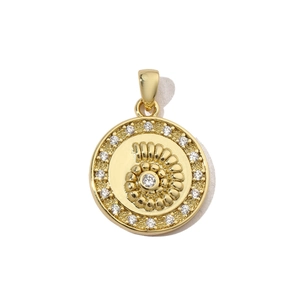 Detailed view of a golden shell pendant with sparkling cubic zirconia on a white background