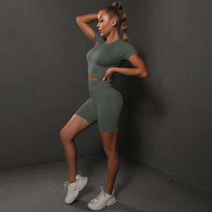 Detail view of seamless olive green yoga set featuring high waist shorts and crop top