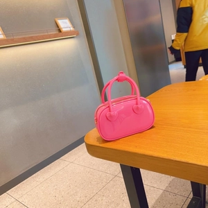 Detailed macro view of pink jelly bag showing PVC material and heart-shaped handle buckle