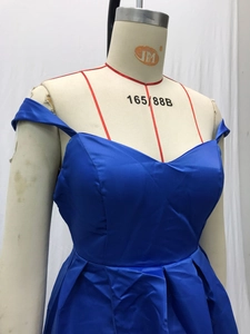 Detail of royal blue satin evening gown featuring off-shoulder sweetheart neckline and pleats