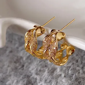 Elegant gold-tone twist C-shape hoop earrings with micro-pave cubic zirconia stones