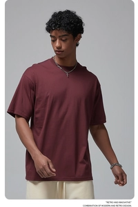 Detail of burgundy oversized cotton T-shirt showing crew neck and drop shoulder fit