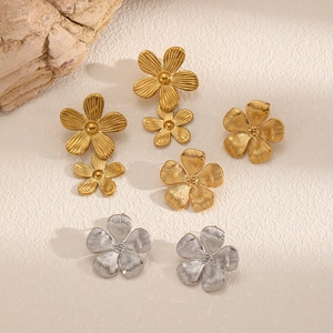 Minimalist stainless steel flower earrings with brushed gold and silver metal textures