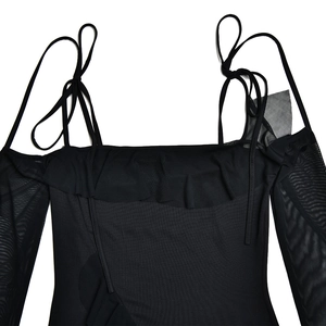 Detail of black mesh off-shoulder dress with thin straps and delicate ruffle chest accents