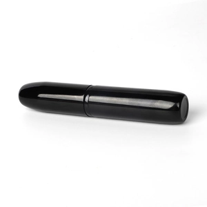 Portable retractable black makeup brush with a sleek cylindrical travel-friendly case