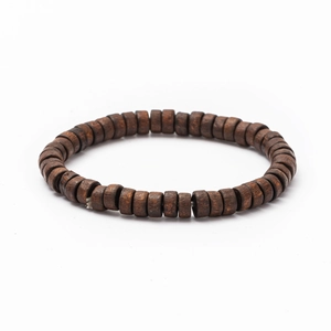 Detailed close-up of dark brown cylindrical wood beads on a multi-layer bracelet