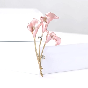 Detailed view of pink calla lily enamel brooch with gold stem and sparkling rhinestones