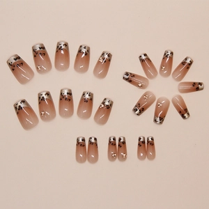 Detail view of French leopard print press-on nails with brown gradient and gold studs
