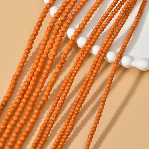 Macro shot of 3mm orange turquoise round spacer beads for DIY jewelry making