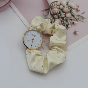 Detail of creative scrunchie watch with beige silk ribbon and rhinestone accents