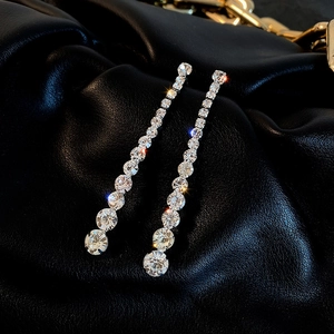 Luxurious silver drop earrings with sparkling gradient rhinestones on black leather