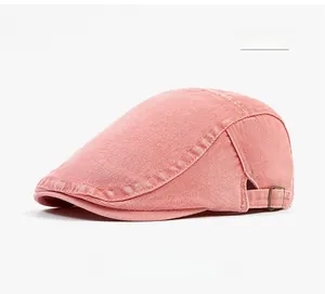 Detail view of pink washed cotton newsboy cap with adjustable metal buckle on side