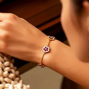 Elegant 18k gold plated flower bracelet with red gems and crystal accents on a thin chain