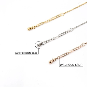 Close-up of gold, silver, and rose gold extension chains with water drop metal beads