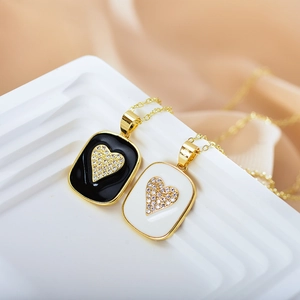 Gold-plated heart pendant necklace with black and white enamel and sparkling zircons