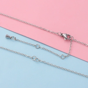 Macro detail of silver stainless steel cable chain with lobster clasp and extension