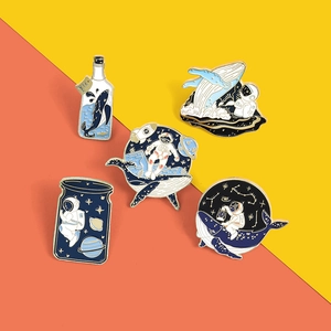 Set of 5 enamel pins featuring astronaut and whale space motifs on colorful background