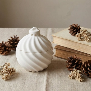White swirl ceramic storage jar with lid on a rustic tabletop home decor scene