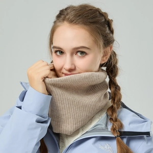 Camel ribbed knit winter neck warmer worn by a model for cold weather outdoor protection