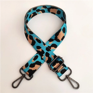 Close-up of leopard print bag strap in blue and brown with gunmetal swivel hooks