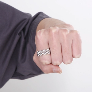 Detail view of a silver stainless steel watch strap ring worn on a model's hand