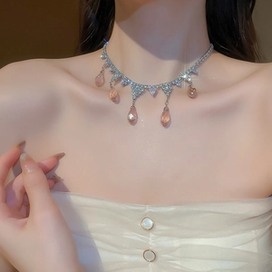 Macro detail of teardrop tassel necklace featuring champagne crystals and zircon inlay