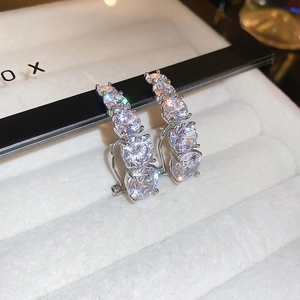 Elegant silver earrings with four graduated round zircon stones in a vertical row