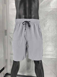 Close-up of gray quick-dry shorts with elastic drawstring waist and side zipper pocket