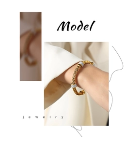 Close-up of golden woven cuff bracelet with sparkling crystal accents worn by a model