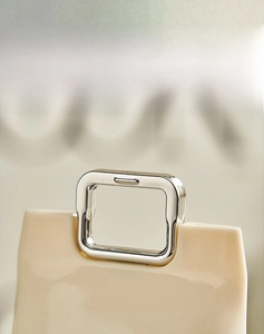 Detail of the cream-colored travel wash cup set featuring a sleek silver metal handle