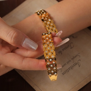 Elegant gold hollow flower bangle with diamond accents on wrist for a chic style